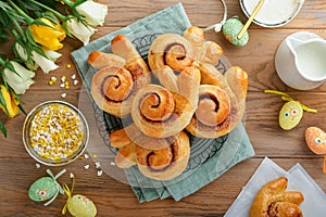 Easter breakfast Holliday concept. Easter bunny buns rolls with cinnamon made from yeast dough with orange glaze, easter photo