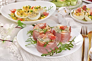 Easter breakfast with vegetable salad wrapped in parma ham and deviled eggs