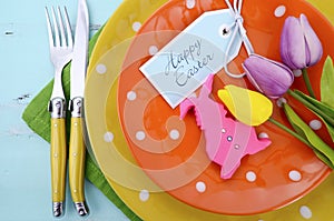 Easter bright color orange, yellow and green polka dot theme table place setting