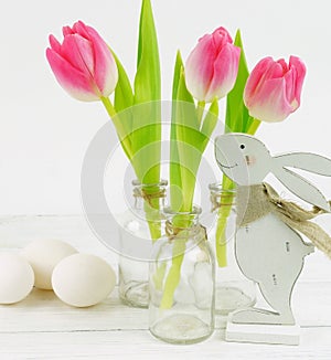 Easter bunnies and a bouquet of pink tulips