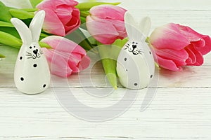 Easter bunnies and a bouquet of pink tulips