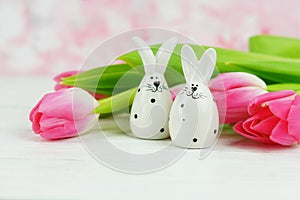 Easter bunnies and a bouquet of pink tulips