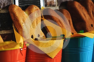 Easter bunny cake in close up picture. Rustic buckets with homemade hot buns ready for Easter time. Easter bunnies bread baked as