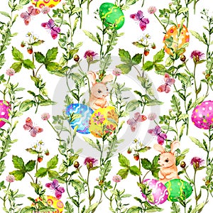 Easter bunny with colored eggs in grass, flowers, butterflies. Seamless floral easter pattern with egg hunt. Watercolor