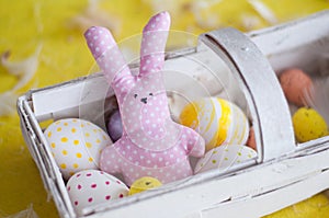 Easter bunny, easter, colored eggs, yellow, white, in a basket, feathers,