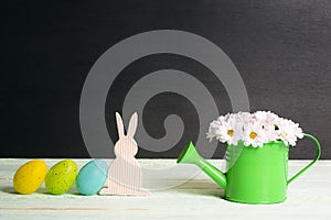 Easter bunny and eggs with daisies bouquet