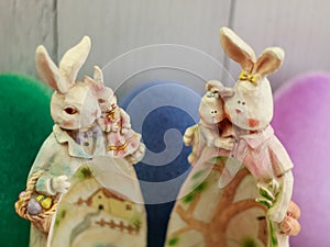 Easter bunny family, egg shape belly with crafty fairy village, colorful Easter eggs