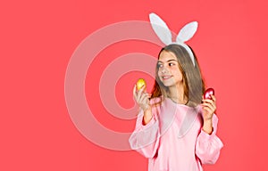 Easter bunny hold painted eggs. happy easter. smiling kid in rabbit ears. Egg hunt on spring holiday. Holiday