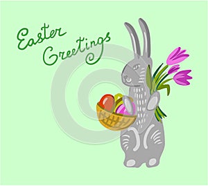 Easter bunny holding a basket with big paschal eggs