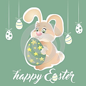 Easter bunny holding green egg with stars