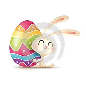 Easter bunny hugs a painted egg.