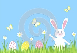 Easter Bunny Rabbit and Eggs on green grass with flowers.