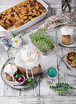 Easter cake with caramelized icing and other festive treats on the white table