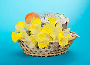 Easter cake, eggs and flowers in basket