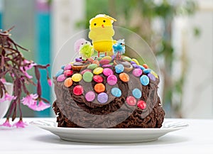 Easter cake by garden window. Fun kids chocolate cake.