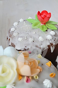 Easter cake with glace icing and flowers, vertical photo