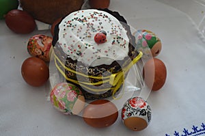 Easter cake with painted eggs lie on the table