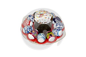 Easter cake and painted eggs on a plate. On white background.