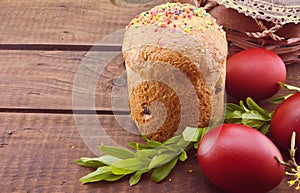 Easter cake and red eggs on rustic wooden table