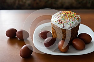 easter cake and red eggs on rustic wooden table. Top view.