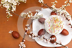 easter cake and red eggs on rustic wooden table. Top view.