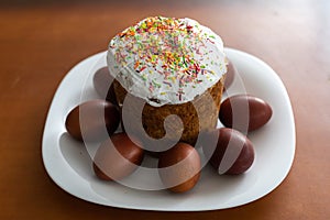 easter cake and red eggs on rustic wooden table. Top view.