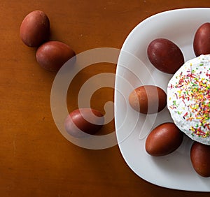 easter cake and red eggs on rustic wooden table. Top view.