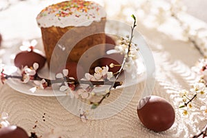 easter cake and red eggs on rustic wooden table. Top view.