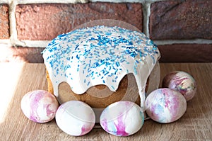 Easter cake with sprinkles on glaze. Happy easter. Dessert. Backery. Spring holiday. Marble shell. Painted eggs. Easter cake on photo