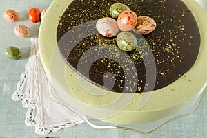 Easter cake with tea matcha decorated chocolate ganache and sweet-stuff eggs