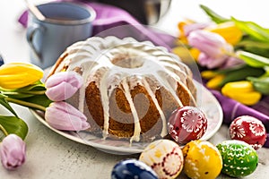 Easter Cake. Traditional ring marble cake withe easter decotation. Easter eggs and spring tulips.