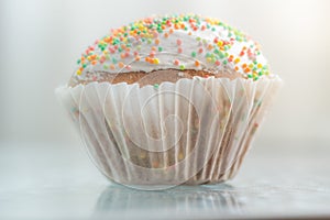 Easter cake wrapped in white paper. Side view, closeup