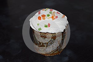 Easter cakes with candied fruit, icing and sprinkles, fresh, side view isolated