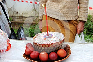 Easter cakes with a candle and colorful Easter eggs. without faces. Orthodox Easter, preparation for consecration with Holy water