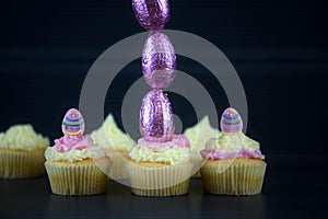 Easter cakes with chocolate eggs in a tall vertical line for creative decorations