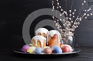 Easter cakes and eggs on a dark, rustic, wooden background