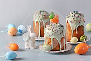 Easter cakes on light blue background with colorful eggs. Spring church holiday concept