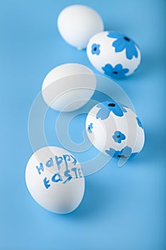 Easter card design. Easter eggs decorated flowers on blue background