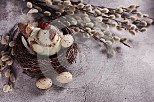 Easter card with a hen figurine in the nest  on beton concrete wall background with empty space for own text photo