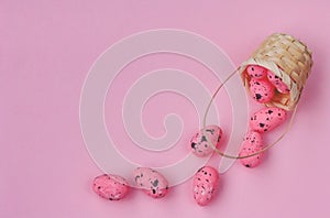 Easter card, small basket with pink decor eggs on paper pink background