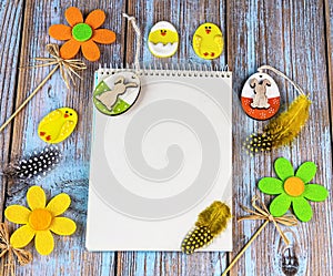 Easter card with yellow and green Easter eggs, decorative flowers, feathers on a wooden background.Generated image