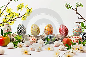 An Easter centerpiece with Easter eggs and chickens on a white background.