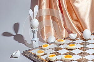 Easter chess play with fresh and boiled eggs