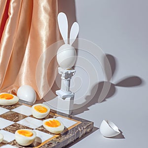 Easter chess play with fresh and boiled eggs