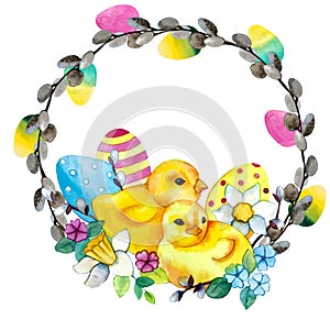 Easter chickens in a wreath of willow branches and eggs