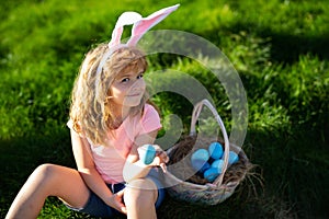 Easter children. Happy Easter. Kids in bunny ears with Easter egg in basket. Boy play in hunting eggs.