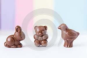 Easter chocolate bunny and teddy bear and bird on white