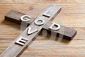 Easter christian wooden cross with an inscription god is love abstract religion background