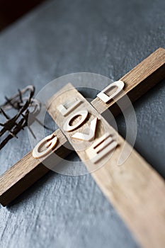 Easter christian wooden cross with an inscription god is love abstract religion background