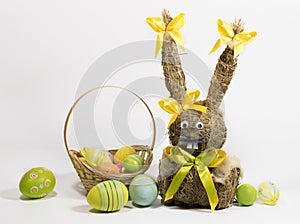 Easter colored eggs and Easter bunny from dry grass.